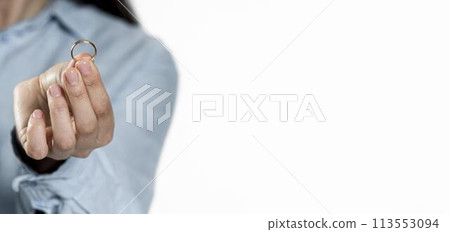 close-up hand holding wedding ring 113553094