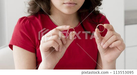 Young girl holding wedding rings 113553095