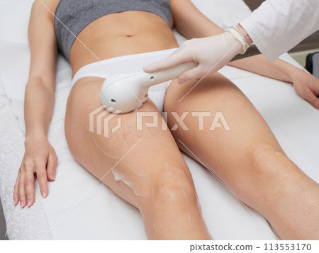 Beautician Removing Hair Of Young Woman body Beautician Removing Hair Of Young Woman body 113553170