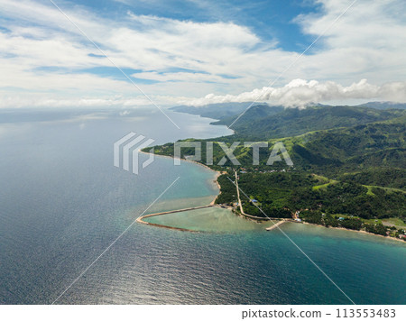 Aerial view of San Agustin with turquoise sea water and coral reefs. Tablas Island. Romblon, Philippines. 113553483
