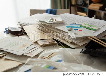 Cash found among piles of documents, secret savings, sorting belongings, messy room 113553515