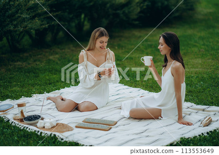 Two young women meditate and do yoga in nature. Two young women meditate and do yoga in nature. 113553649