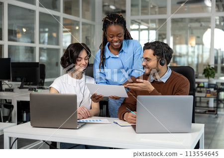 Team working on new project discussing ideas using laptops 113554645