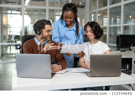 Team working on new project discussing ideas using laptops 113554648