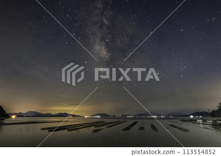 Summer starry scenery of Setouchi: Sea lined with oyster racks and the Milky Way 113554852