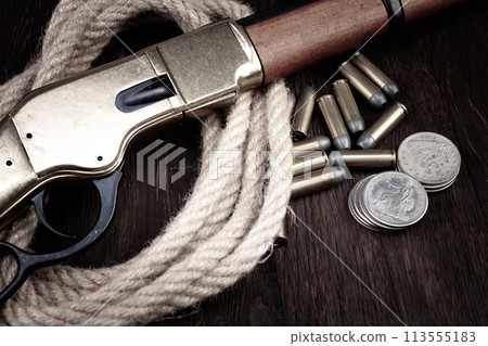 Old west lever action repeating rifle with ammunition and silver dollar coins. Old west lever action repeating rifle with ammunition and silver dollar coins. 113555183