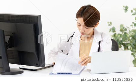 Woman in white coat online medical consultation Woman in white coat online medical consultation 113555826