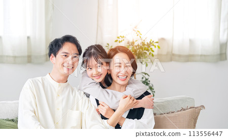 Parent and child hugging in the living room Parent and child hugging in the living room 113556447