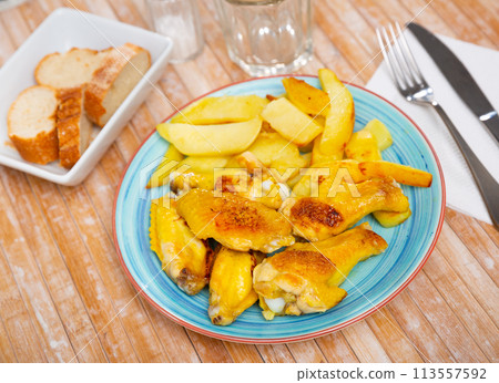 Crispy grilled chicken wings served with potato 113557592