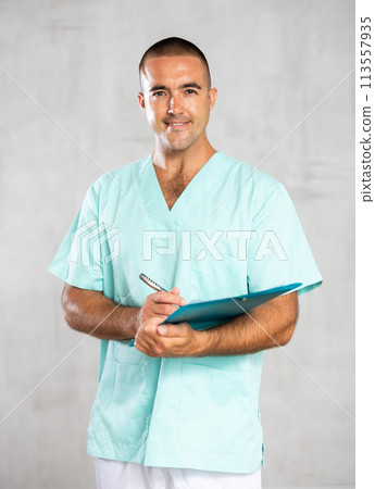 Doctor attentively fills 113557935