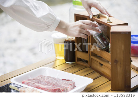 Barbecue image A woman's hand taking out seasonings from a seasoning bowl 113558319