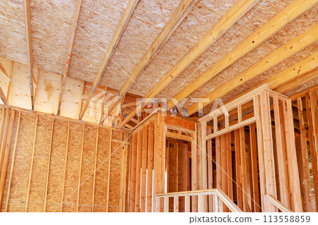 During construction of framing beam layout joists supports truss framework for wooden new house 113558859