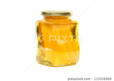 Glass jar filled with honey and honeycomb isolated on white Glass jar filled with honey and honeycomb isolated on white 113558969