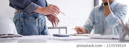 Male engineer architect explain about technical for construction plan and interior architectural building to partner while working to brainstorming about business planning together in workplace site Male engineer architect explain about technical for construction plan and interior architectural building to partner while working to brainstorming about business planning together in workplace site 113559524