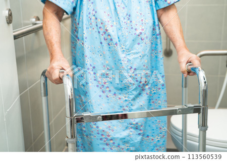 Asian elderly woman patient use toilet bathroom handle security in nursing hospital, healthy strong medical concept. Asian elderly woman patient use toilet bathroom handle security in nursing hospital, healthy strong medical concept. 113560539