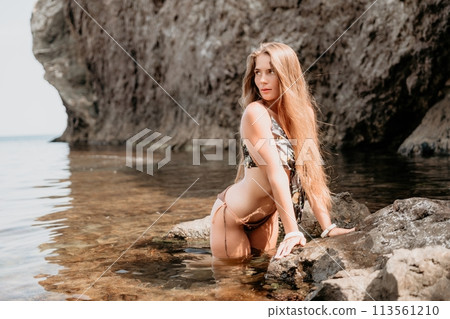 Woman travel sea. Happy tourist enjoy taking picture outdoors for memories. Woman traveler swim in the sea bay with mountains, sharing travel adventure journey 113561210