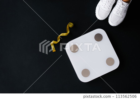 Flat lay scales, trainers and tape measure. Weight control concept 113562506