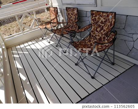 Wooden deck terrace with folding chairs Wooden deck terrace with folding chairs 113562605