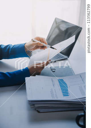 Cheerful business lady working on laptop in office, Asian happy beautiful businesswoman in formal suit work in workplace. Attractive female employee office worker smile. Cheerful business lady working on laptop in office, Asian happy beautiful businesswoman in formal suit work in workplace. Attractive female employee office worker smile. 113562799