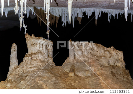 Mysterious Stalagmites and Stalactites in a Dark Cave 113563531