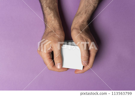 Male hand holding pills boxes in front of purple background mock-up series Male hand holding pills boxes in front of purple background mock-up series 113563799