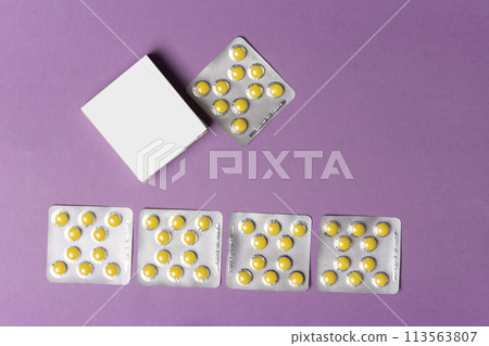 Pills tablets beside box in front of purple background mock-up series  113563807