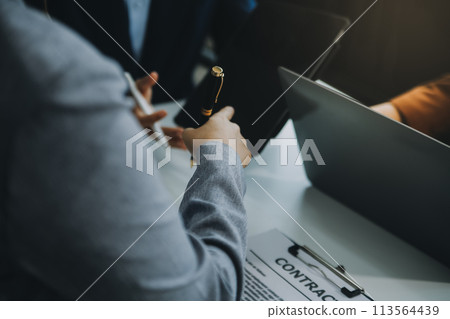 Businessman and lawyer discuss the contract document. Treaty of the law. Sign a contract business. Businessman and lawyer discuss the contract document. Treaty of the law. Sign a contract business. 113564439