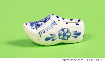 Miniature dutch wooden shoe souvenir on white background, typical dutch souvenir 113564948