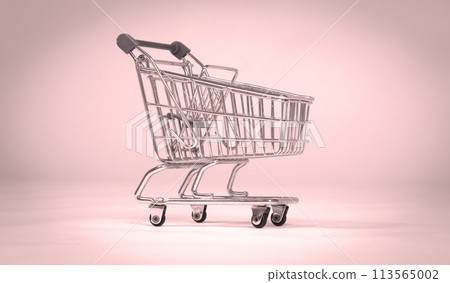 Small shopping cart isolated on solid background Small shopping cart isolated on solid background 113565002