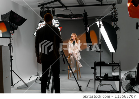 Film crew on set for the filming of a TV interview. Broadcasting TV show. 113565707