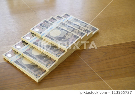 A stack of bills on a desk 113565727