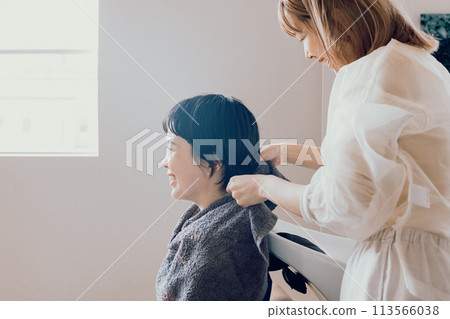 Young woman receiving counseling at a beauty salon Young woman receiving counseling at a beauty salon 113566038