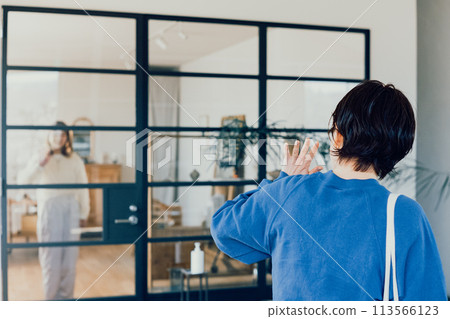 Two young women waving 113566123