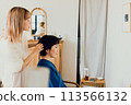 Young woman having her hair done at a beauty salon 113566132