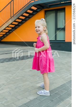 Child girl with hearing aid and cochlear implantation system. Kid with hearing problems walks outdoor in summer. Inclusion and diversity concept Child girl with hearing aid and cochlear implantation system. Kid with hearing problems walks outdoor in summer. Inclusion and diversity concept 113568224