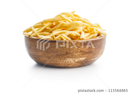 Uncooked spaetzle pasta in bowl isolated on white background. Uncooked spaetzle pasta in bowl isolated on white background. 113568865