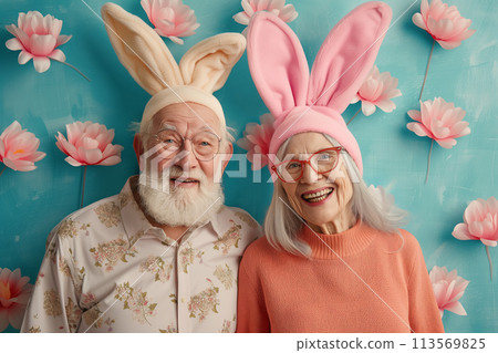 Happy old couple in bunny ears on festive background. Easter concept 113569825