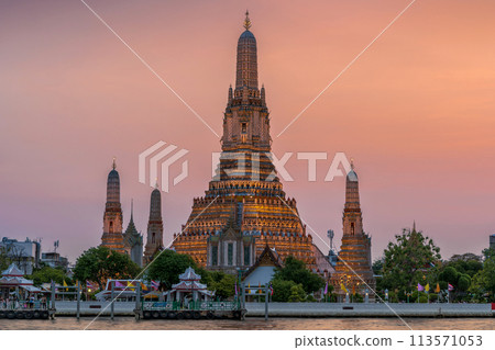 Wat Arun stupa, a significant landmark of Bangkok, Thailand, stands prominently along the Chao Phraya River, with a beautiful twilight. Wat Arun stupa, a significant landmark of Bangkok, Thailand, stands prominently along the Chao Phraya River, with a beautiful twilight. 113571053