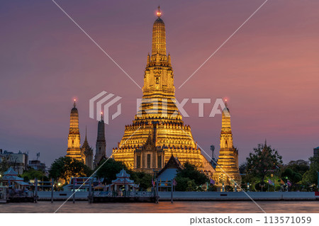 Wat Arun stupa, a significant landmark of Bangkok, Thailand, stands prominently along the Chao Phraya River, with a beautiful twilight. Wat Arun stupa, a significant landmark of Bangkok, Thailand, stands prominently along the Chao Phraya River, with a beautiful twilight. 113571059