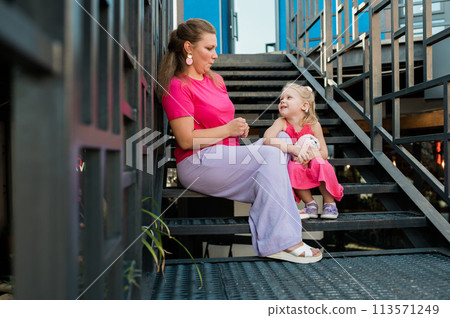 Deaf child with cochlear implant for hearing audio and aid for impairment having fun and laughs with mother outdoor in summer. Sound fitting device to help with communication listening and interaction Deaf child with cochlear implant for hearing audio and aid for impairment having fun and laughs with mother outdoor in summer. Sound fitting device to help with communication listening and interaction 113571249