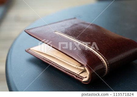 Brown leather wallet for men on a table, Belgium Brown leather wallet for men on a table, Belgium 113571824