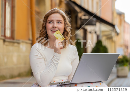 Woman using credit bank card laptop computer while transferring money purchases online shopping Woman using credit bank card laptop computer while transferring money purchases online shopping 113571859