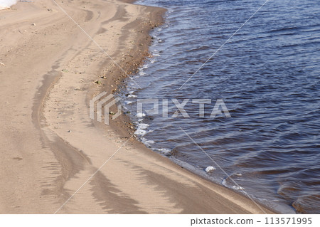 nature in winter on the banks of the Volga, ice with sand and snow, river sandy background. nature in winter on the banks of the Volga, ice with sand and snow, river sandy background. 113571995
