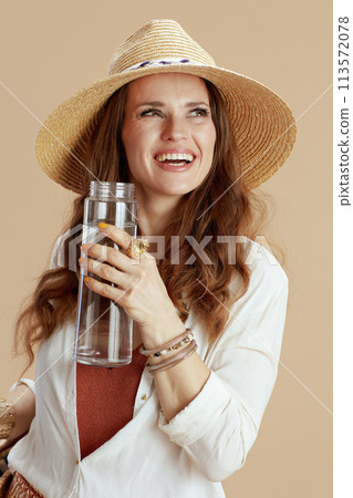 happy elegant woman in blouse and shorts isolated on beige 113572078