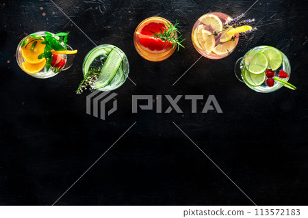 Fancy cocktails with fresh fruit. Gin and tonic drinks with ice at a party Fancy cocktails with fresh fruit. Gin and tonic drinks with ice at a party 113572183