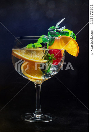 Fancy cocktail with fresh fruit. Gin and tonic drink with ice at a party 113572191