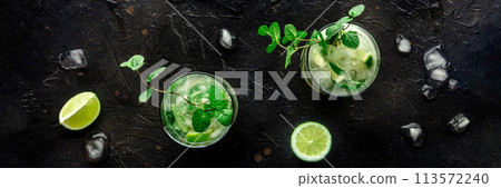 Mojito cocktail. Summer cold drink with lime, fresh mint, and ice. Cool beverage 113572240