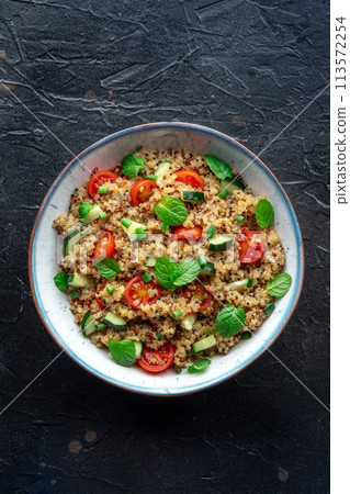 Quinoa tabbouleh salad in a bowl, a healthy dinner with tomatoes and mint 113572254