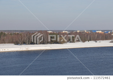 river on a sunny day. Trees and shrubs. Landscape of winter nature, river banks with bushes. 113572461