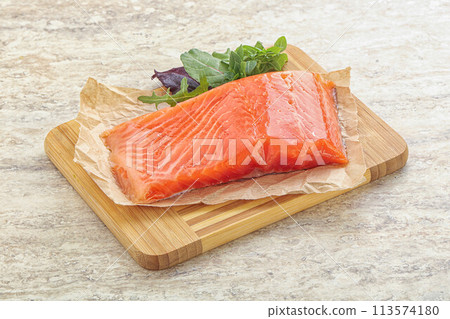 Raw salmon fillet over board 113574180